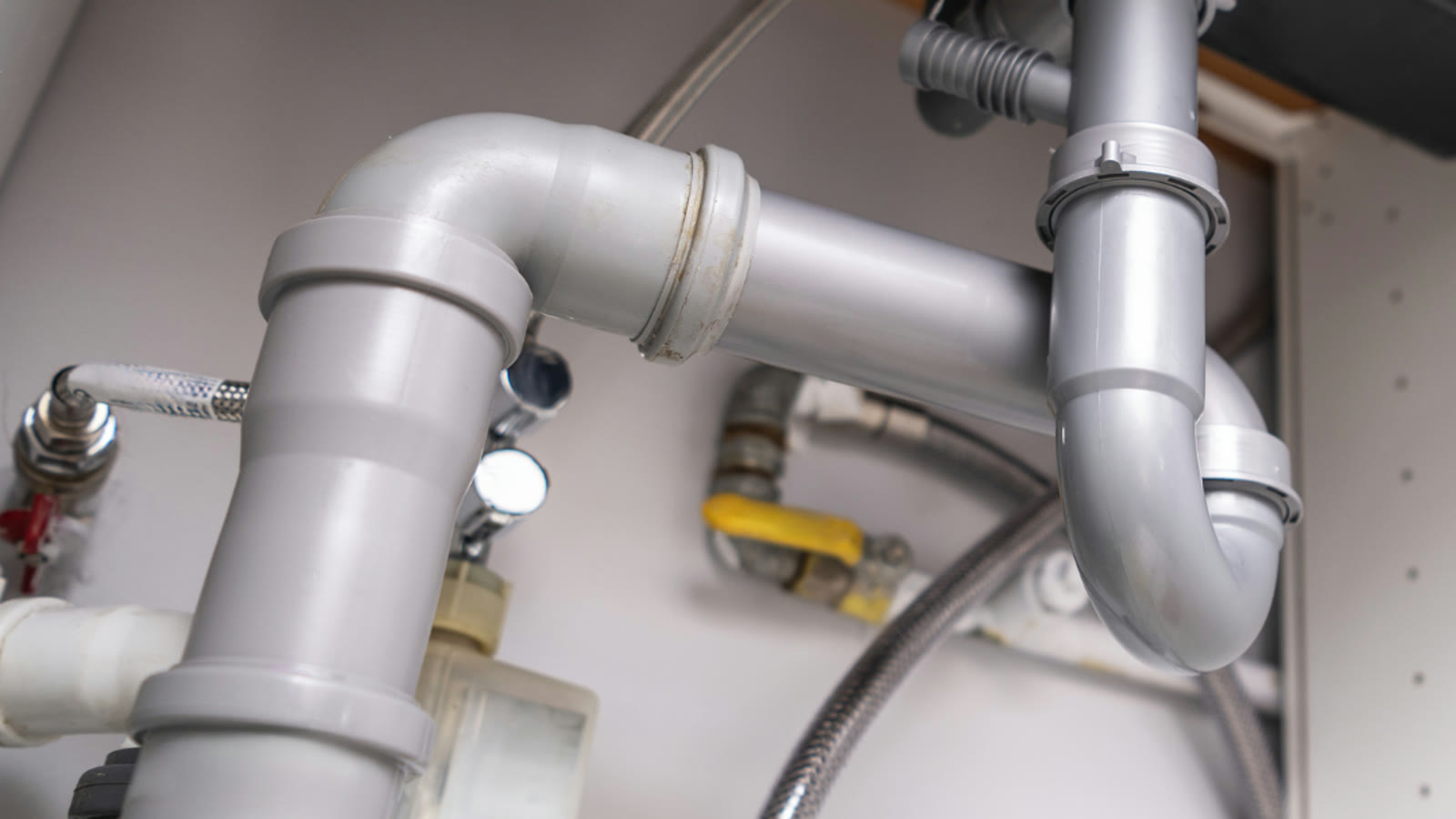 Drain and supply connections beneath a residential sink